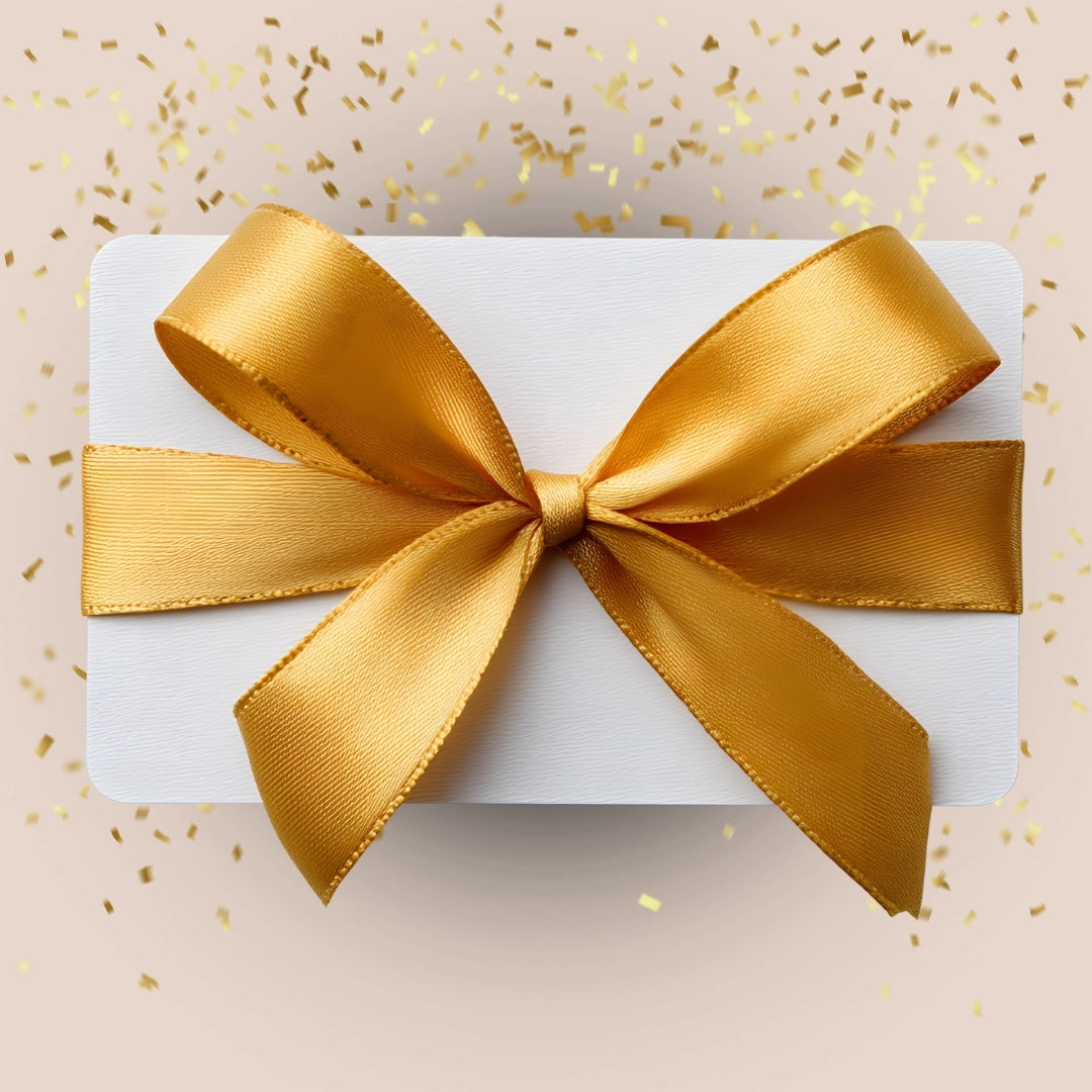 White gift card with a large gold bow on a beige background with gold confetti.