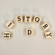 Cubes with letters spelling 'HISTORY' on a light background