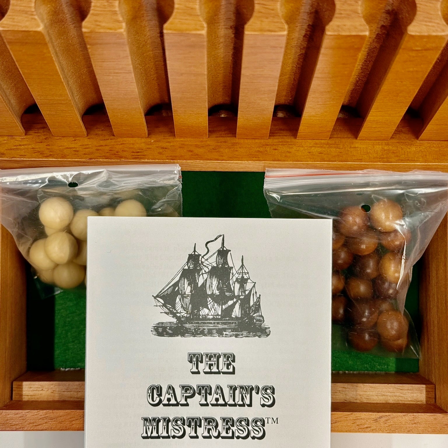 Card with ship illustration and 'The Captain's Mistress' text on top of a Captain's Mistress game.