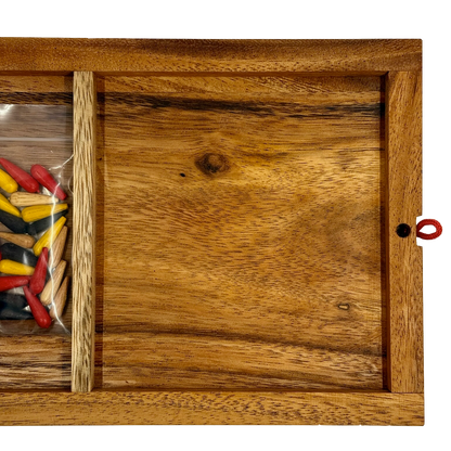 Back of wooden Cribbage board with colorful pieces stored inside