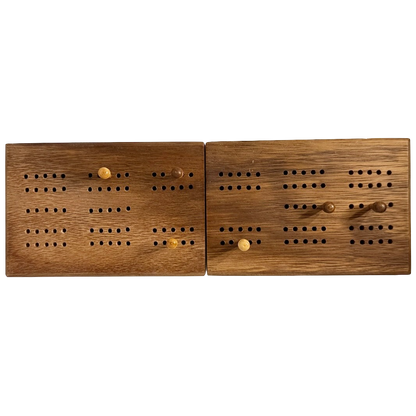 Pair of wooden cribbage boards with pegs on a white background