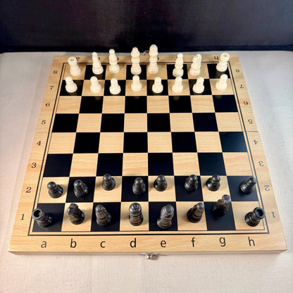 Wooden chessboard with black and white chess pieces.