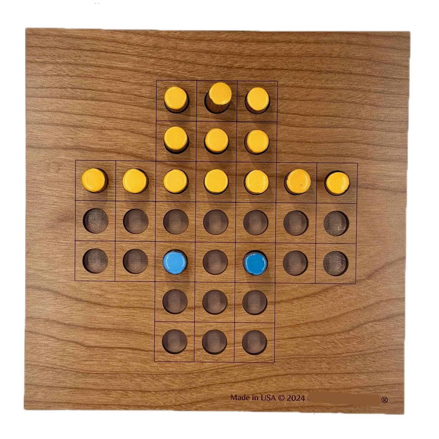 Wooden Solitaire game board with yellow and blue pieces 