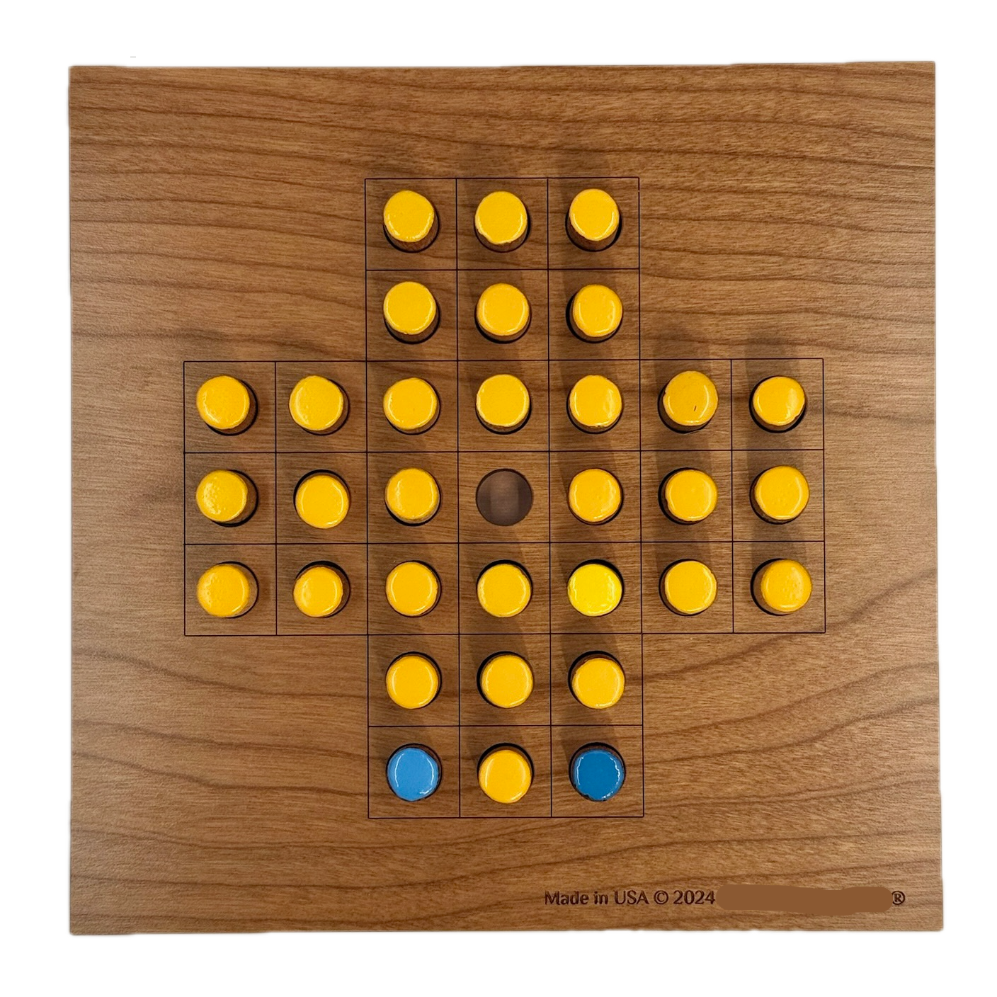 Wooden Solitaire game board with yellow and blue pieces 