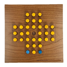 Wooden Solitaire game board with yellow and blue pieces 