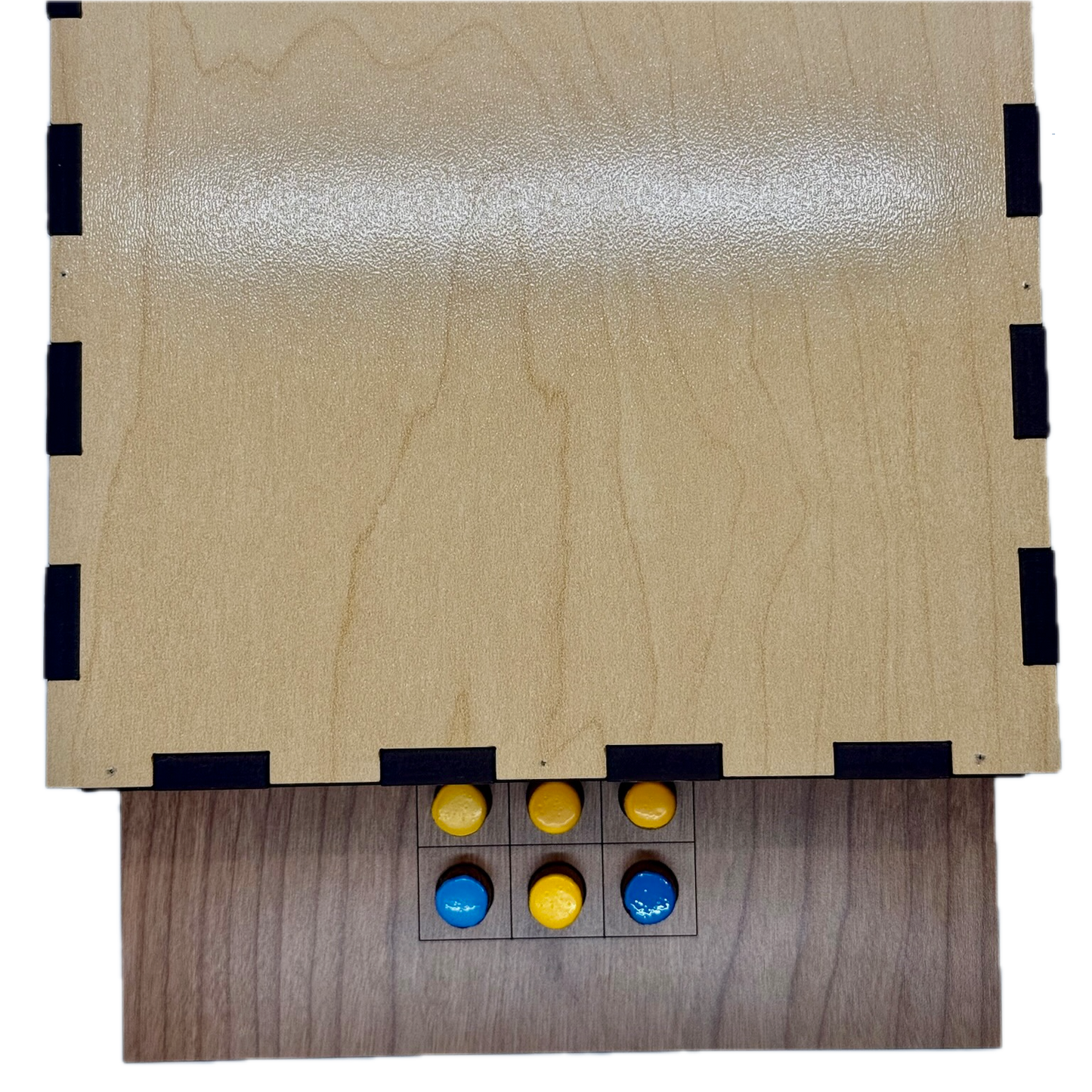 Back of wooden Solitaire game board with yellow and blue pieces 