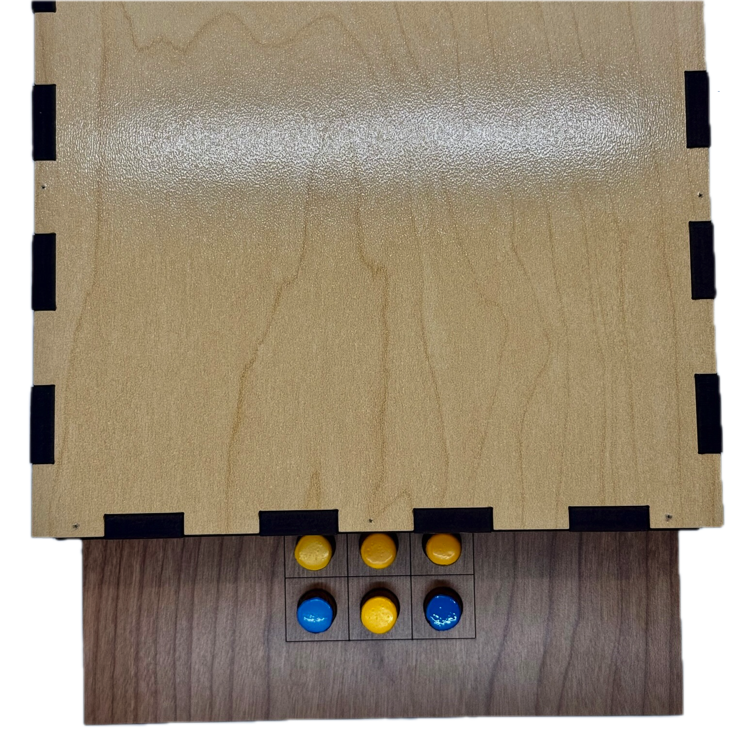 Back of wooden Solitaire game board with yellow and blue pieces 