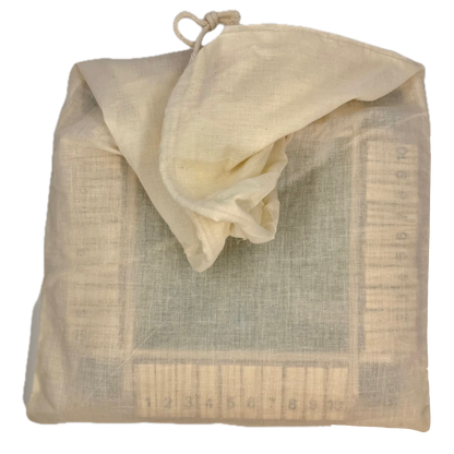 Beige drawstring bag containing wooden Shut the Box game