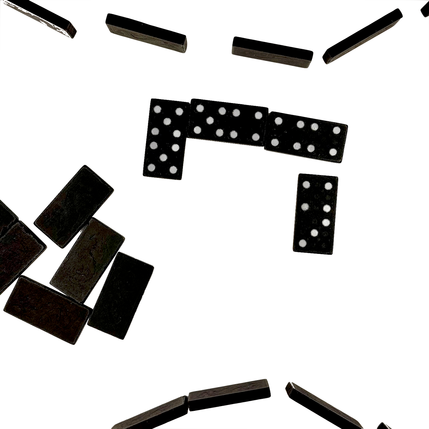 Black dominoes with white dots scattered on a white background