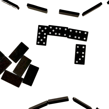 Black dominoes with white dots scattered on a white background