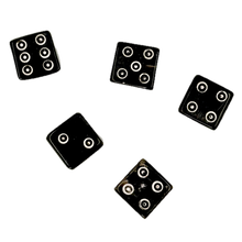 Five black horn dice with circular patterns on a white background