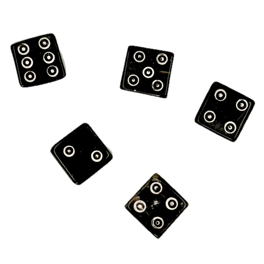 Five black horn dice with circular patterns on a white background