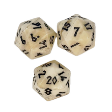 Three white polyhedral dice with black numbers on a white background