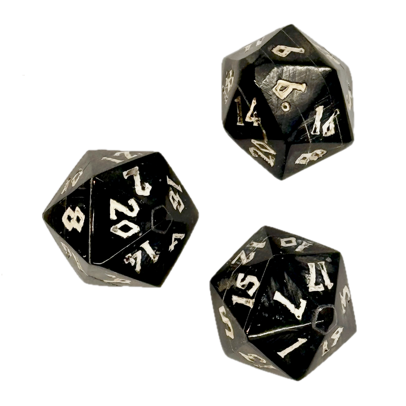 Three black polyhedral horn dice with white numbers on a white background