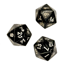 Three black polyhedral horn dice with white numbers on a white background