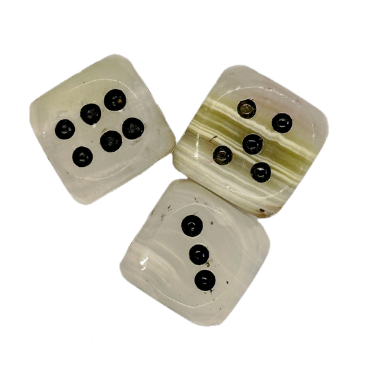 Three onyx dice with black markings on a white background