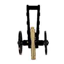 Brass replica Trail Cannon toy on a white background