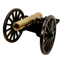 Brass replica Trail Cannon toy on a white background