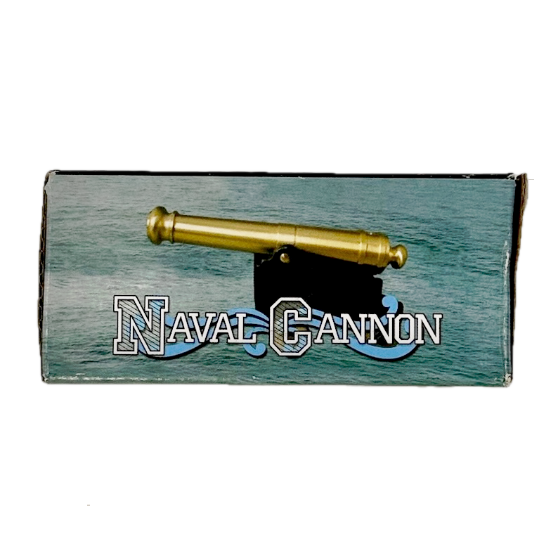 Brass replica ship cannon box reading "Naval Cannon" on a white background