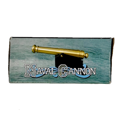 Brass replica ship cannon box reading "Naval Cannon" on a white background