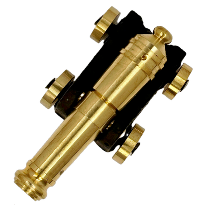 Brass replica ship cannon on a white background