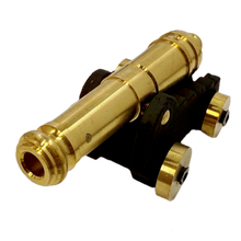Brass replica ship cannon on a white background