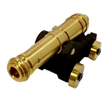 Brass replica ship cannon on a white background