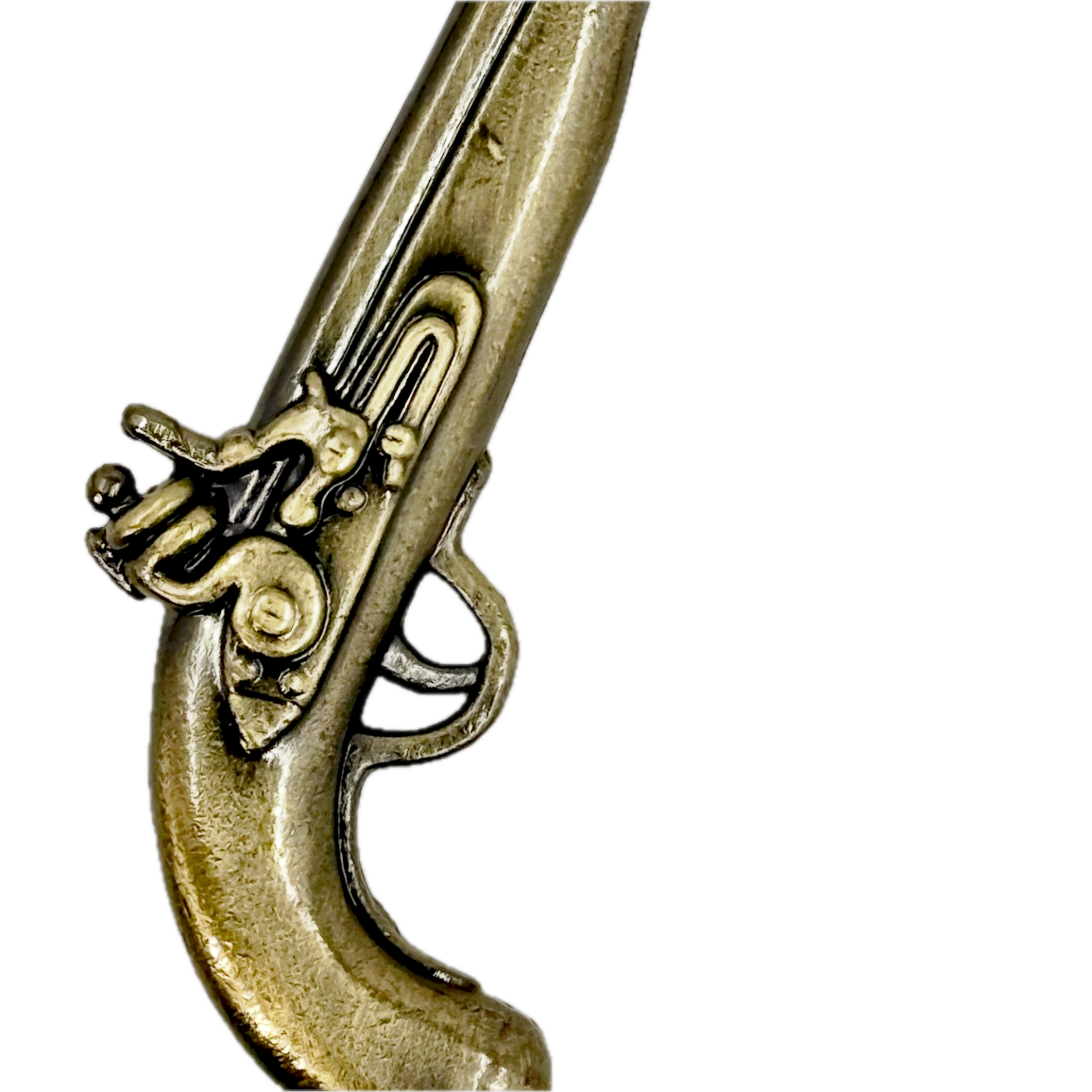 Close-up of a replica pewter cast pistol toy on a white background