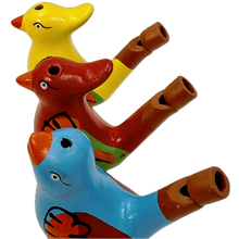 Three bird-shaped whistles in yellow, red, and blue on a white background