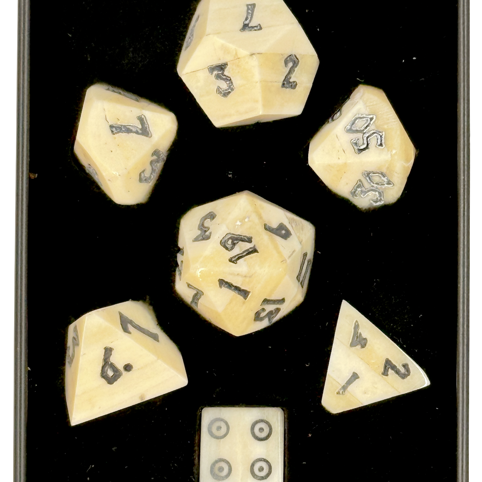 Set of polyhedral bone dice with numbers in a black box