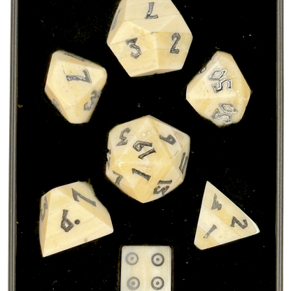 Set of polyhedral bone dice with numbers in a black box
