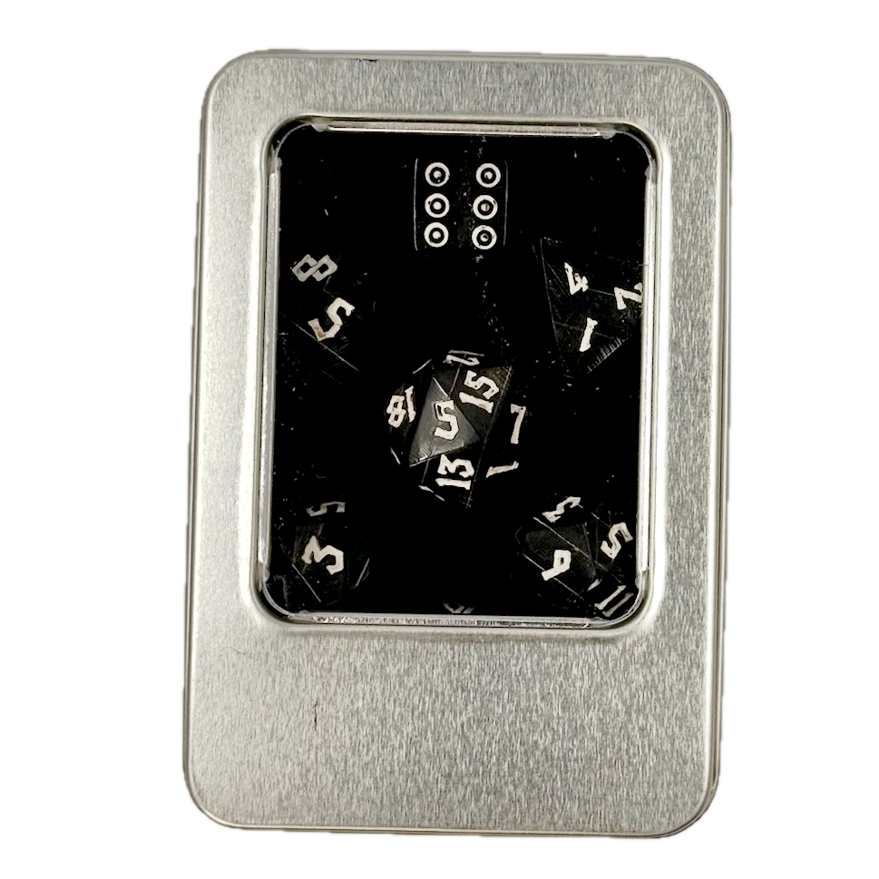 Metal dice case with polyhedral horn dice inside on a white background