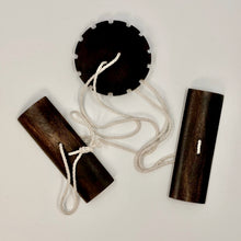 Wooden buzz saw toy on a light background