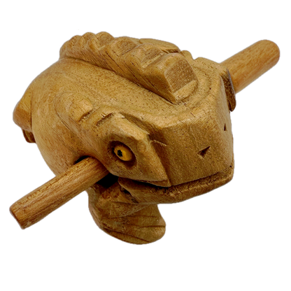 Wooden Croaky Frog toy with a stick in its mouth on a white background
