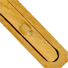 Close-up of a wooden Snake in the Box toy on a white background