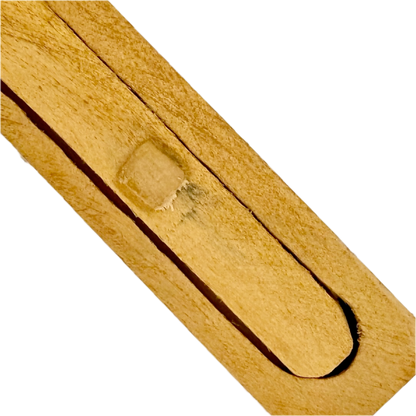 Close-up of a wooden Snake in the Box toy on a white background
