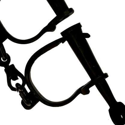 Close-up of black iron shackles on a white background