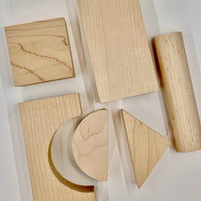 Set of wooden geometric shape blocks on a white background