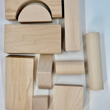 Wooden building blocks of various shapes on a white background