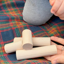 Wooden blocks on a colorful plaid fabric
