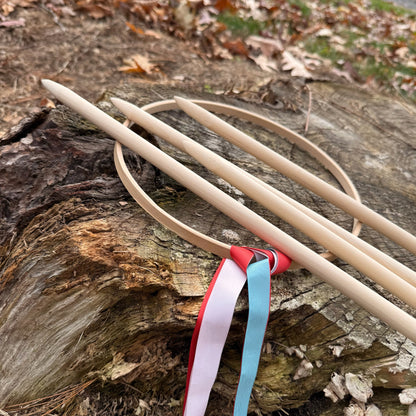 Wooden Graces game with ribbons on a log