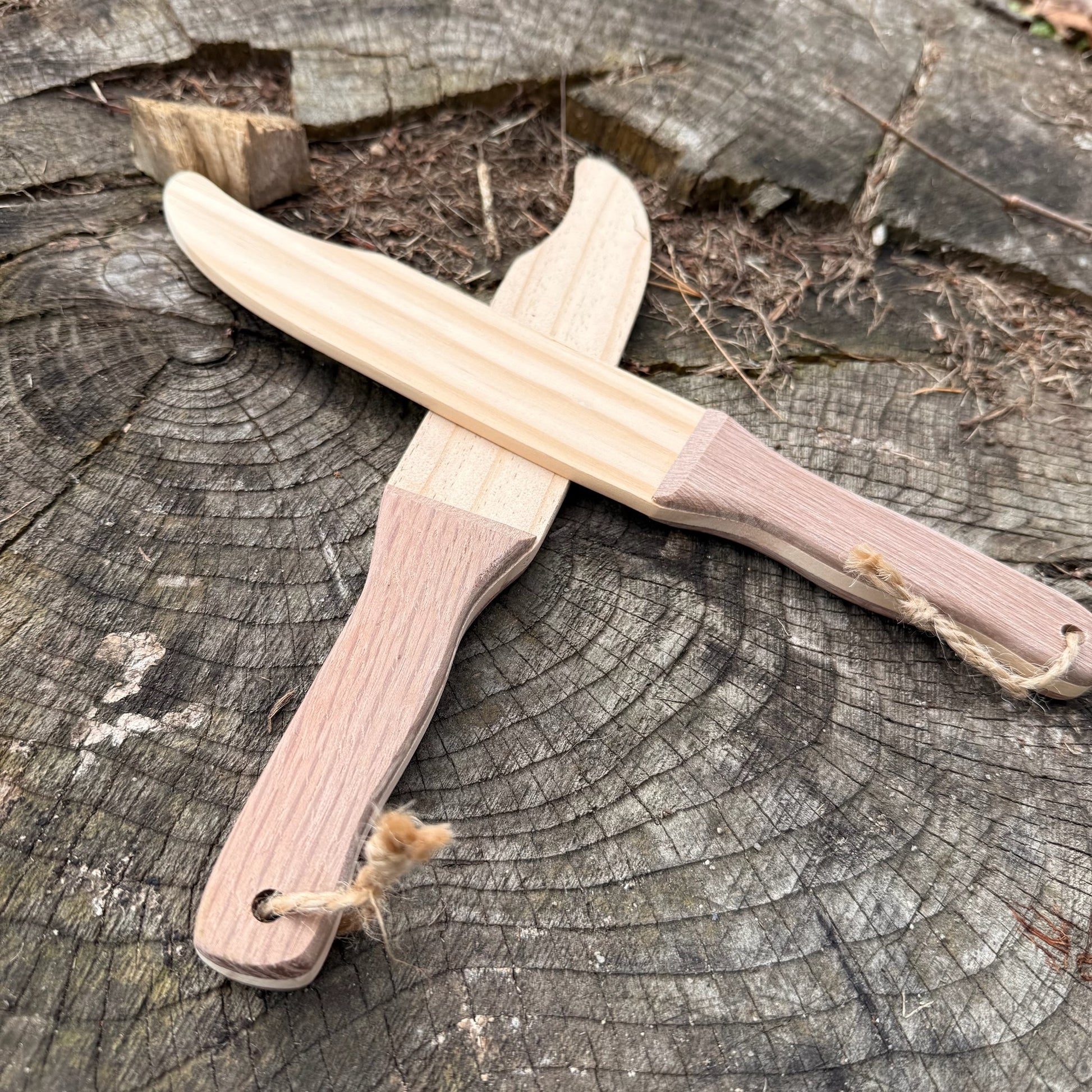 Wooden toy knives on a tree stump