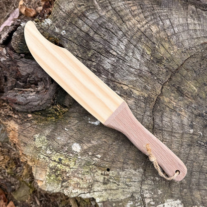 Wooden toy knife on a wooden surface