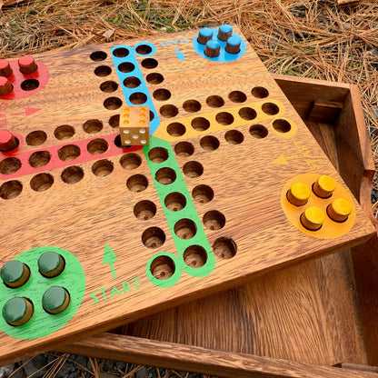 Wooden Ludo board game with colorful pegs and dice on a natural background