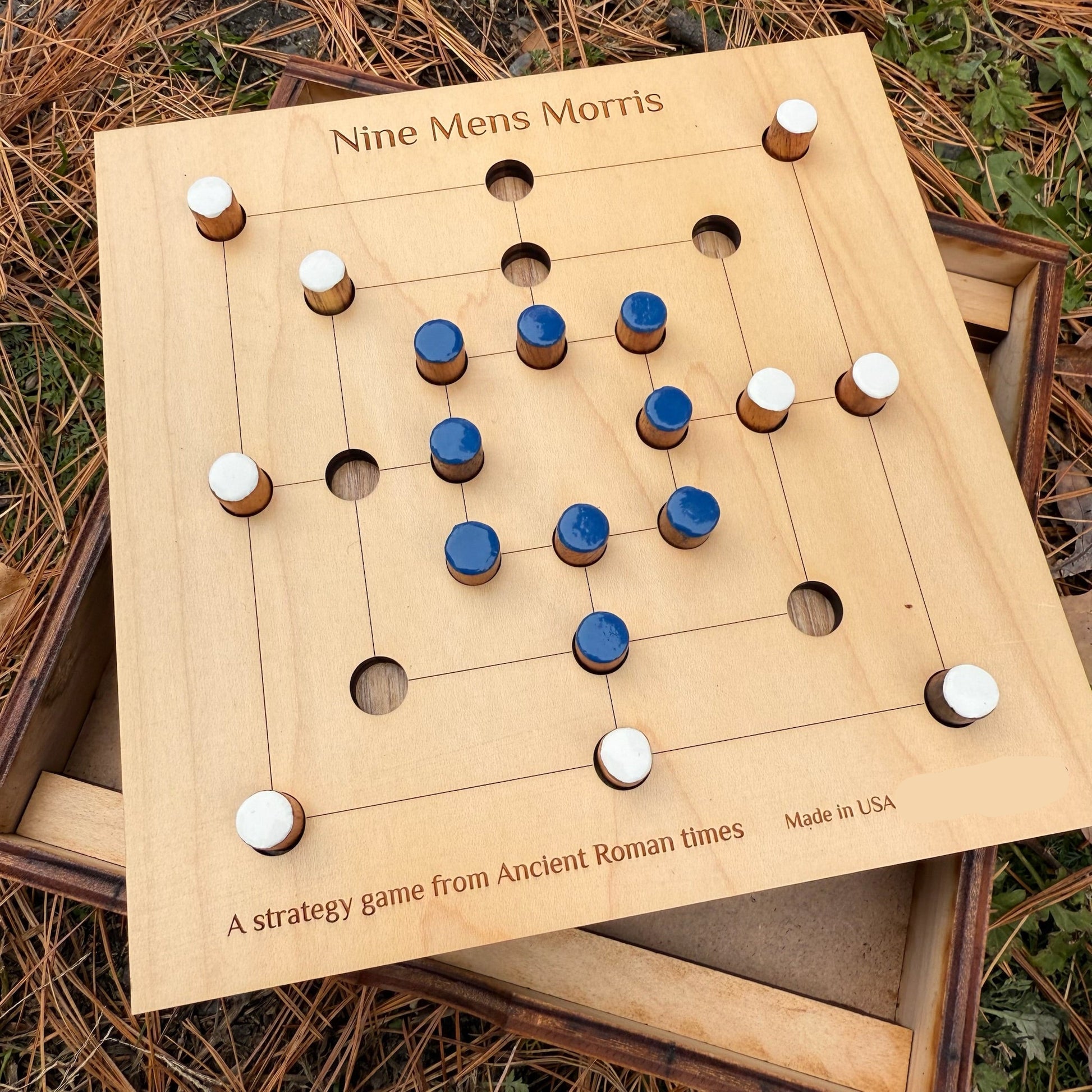 Wooden Nine Men's Morris game set on a natural background