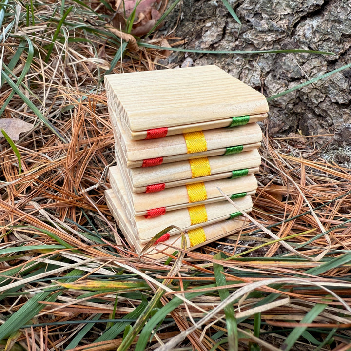 Jacob's Ladder toy with colorful ribbon bindings on a natural background