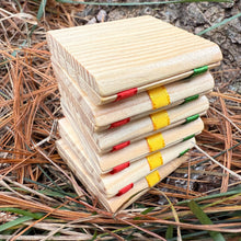 Jacob's Ladder toy with colorful ribbon bindings on a natural background